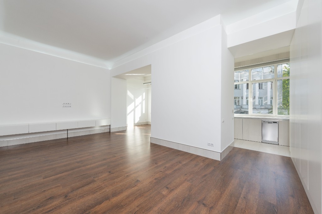 Dark wood flooring installation in a bright modern interior by Ikveles Construction