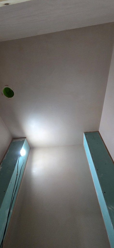 Smooth plaster finish on alcove walls and ceiling during renovation by Ikveles Construction