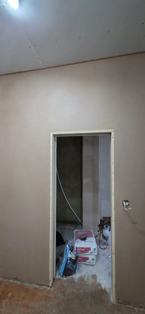 Smooth plastered wall with doorway opening during renovation by Ikveles Construction